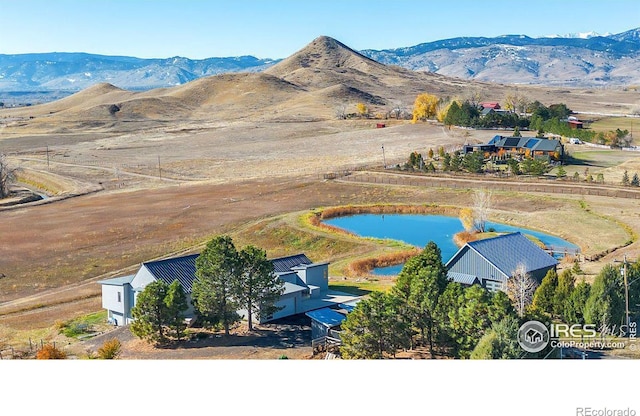 aerial view featuring a water and mountain view