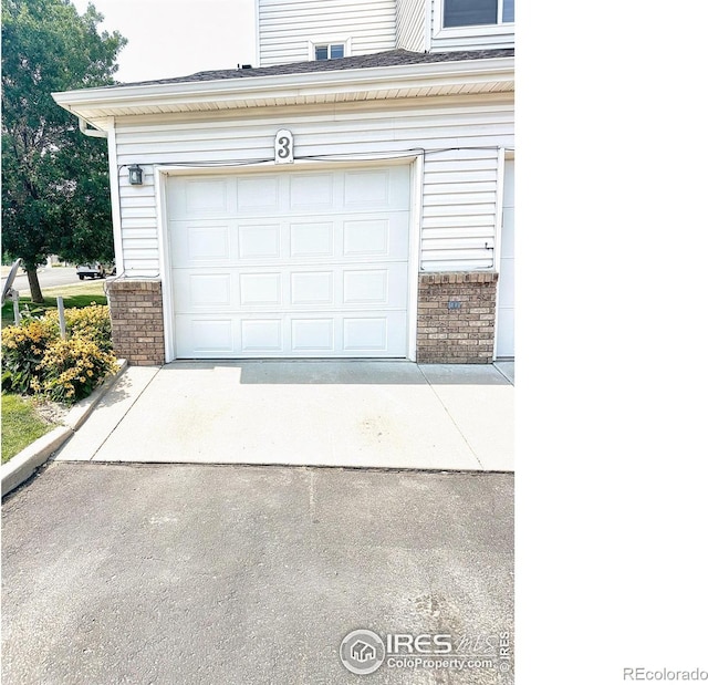 garage with concrete driveway