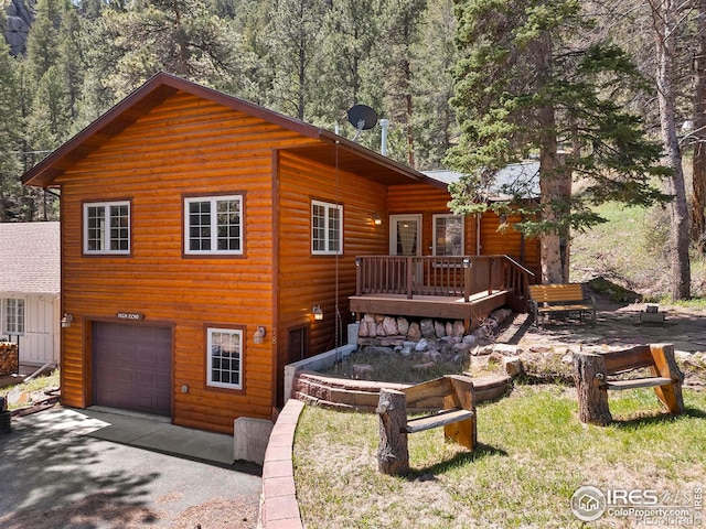 view of front of house with a deck and a garage