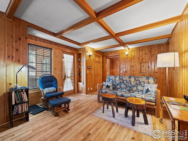 living room featuring wood walls, light hardwood / wood-style flooring, beamed ceiling, and coffered ceiling