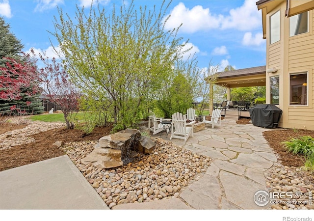 view of patio with a fire pit and area for grilling