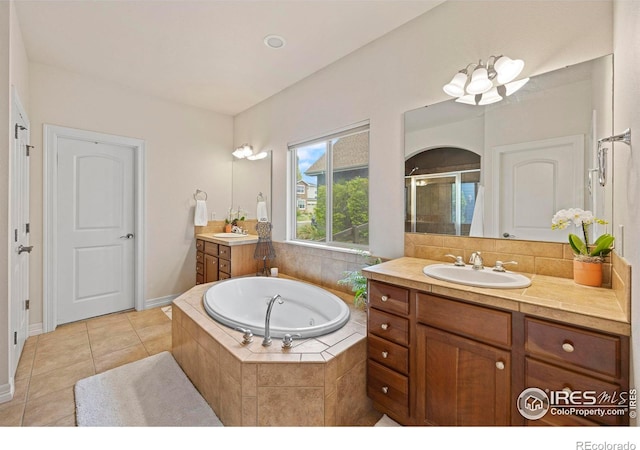 bathroom with vanity, tile patterned flooring, and separate shower and tub