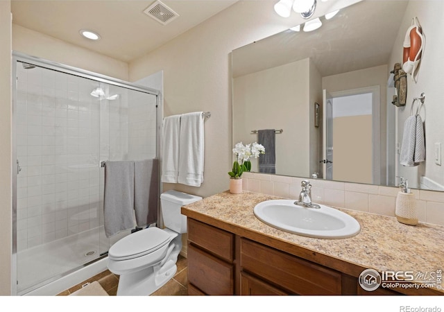 bathroom featuring walk in shower, tile patterned floors, vanity, and toilet