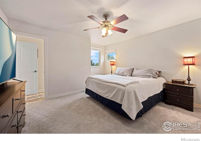 bedroom with light colored carpet and ceiling fan