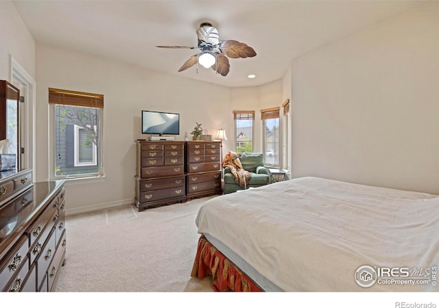 carpeted bedroom with multiple windows and ceiling fan