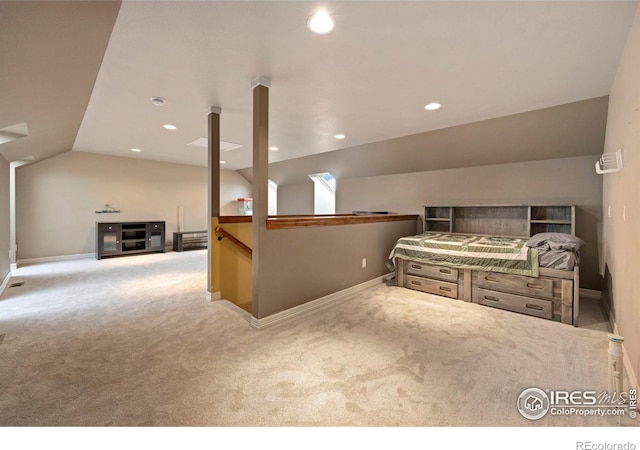 carpeted bedroom with lofted ceiling