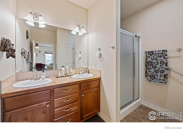 bathroom featuring tile patterned floors, vanity, a shower with door, and ceiling fan