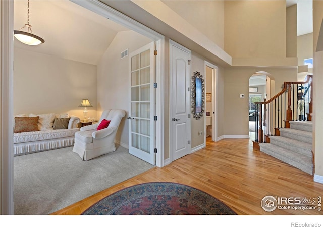 foyer featuring lofted ceiling and hardwood / wood-style flooring