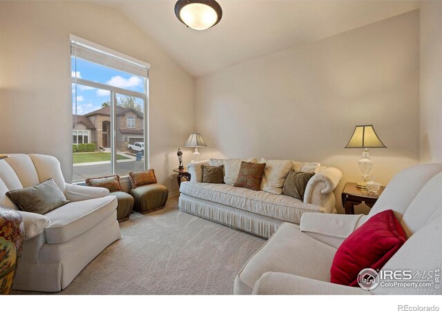 carpeted living room featuring vaulted ceiling