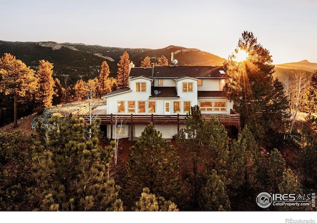 back house at dusk with a mountain view