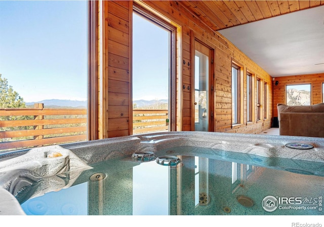 view of pool featuring a hot tub and a mountain view