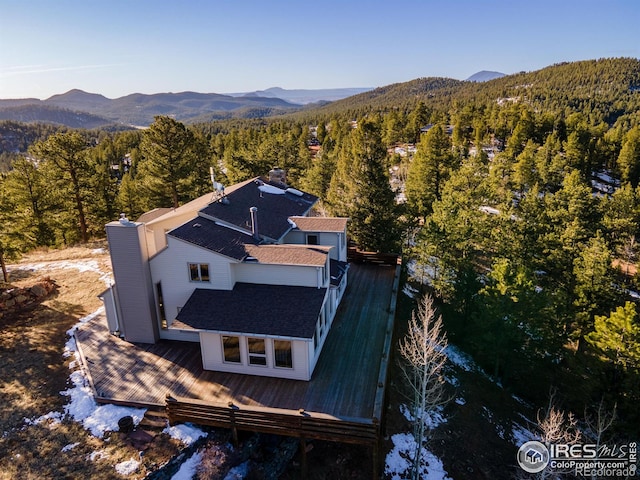 birds eye view of property with a forest view and a mountain view