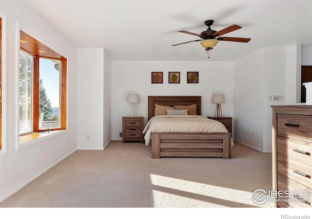 bedroom with multiple windows, light colored carpet, and ceiling fan