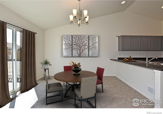 dining room featuring a notable chandelier, lofted ceiling, sink, and a wealth of natural light