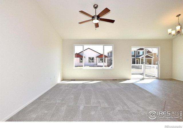 unfurnished living room with ceiling fan with notable chandelier and light colored carpet