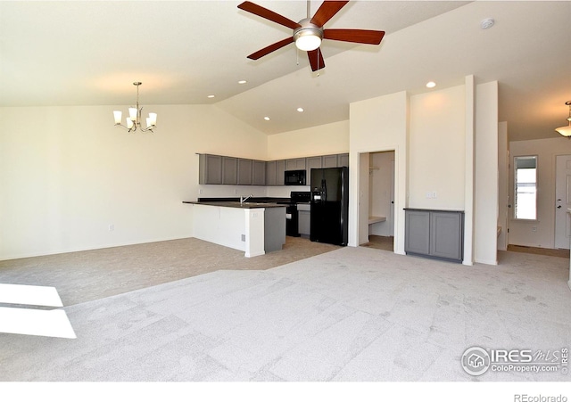 kitchen featuring ceiling fan with notable chandelier, decorative light fixtures, light colored carpet, and black appliances