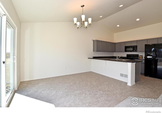 kitchen featuring kitchen peninsula, sink, black appliances, a notable chandelier, and hanging light fixtures