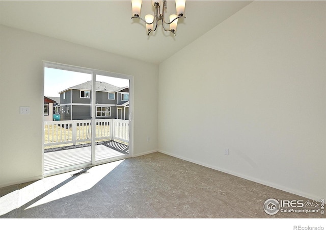 empty room featuring lofted ceiling and a chandelier