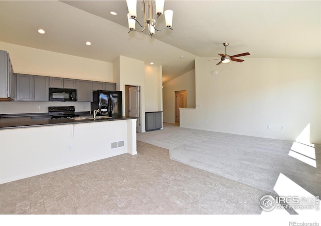 kitchen with gray cabinetry, light carpet, black appliances, ceiling fan with notable chandelier, and decorative light fixtures