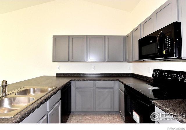 kitchen featuring gray cabinets, sink, black appliances, and vaulted ceiling