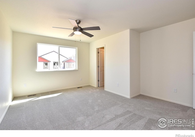 spare room with light carpet and ceiling fan