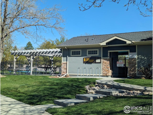 view of front of home with a fenced in pool and a front yard