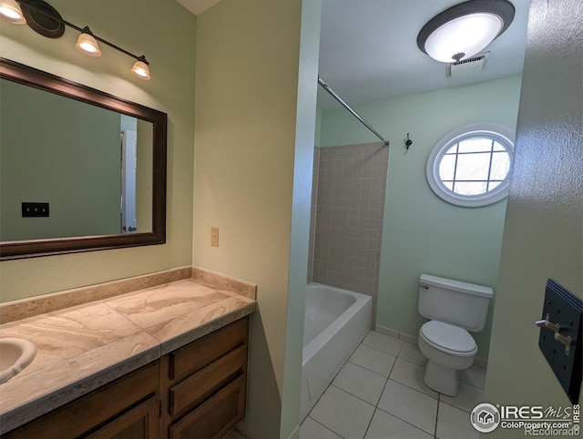 full bathroom with tile flooring, tiled shower / bath, vanity, and toilet