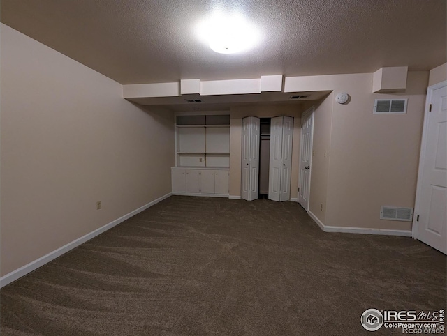 carpeted spare room featuring a textured ceiling