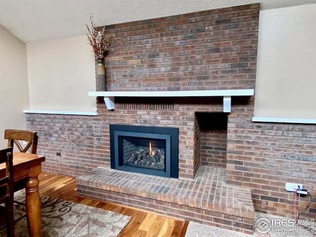 room details with a fireplace, hardwood / wood-style floors, and a textured ceiling