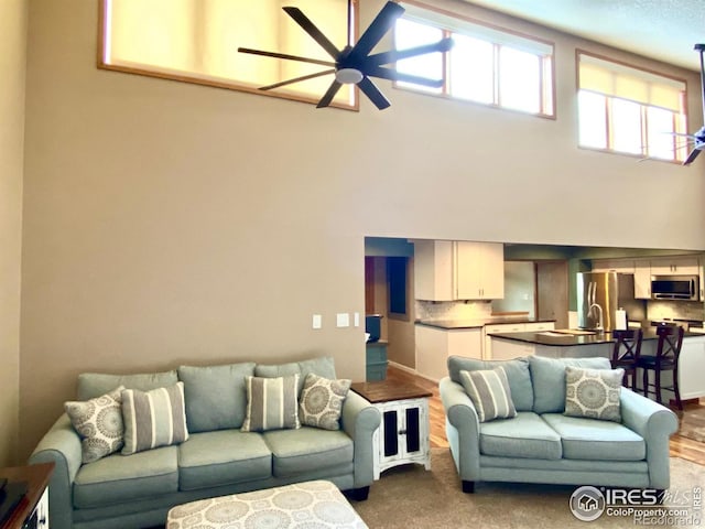 living room with hardwood / wood-style flooring and ceiling fan