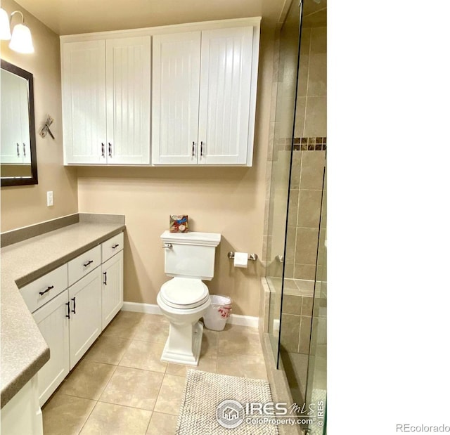 bathroom featuring tile patterned flooring, vanity, and toilet