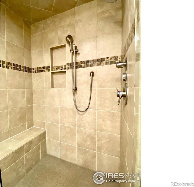 bathroom with tiled shower