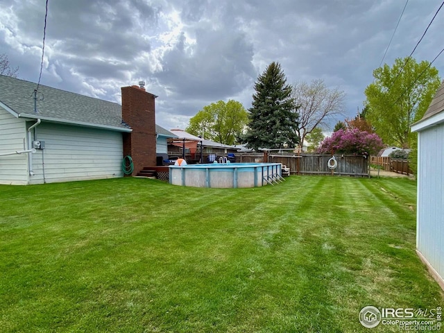 view of yard with a fenced in pool