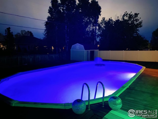 view of pool featuring a storage shed