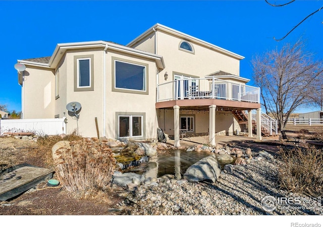 rear view of property featuring a deck