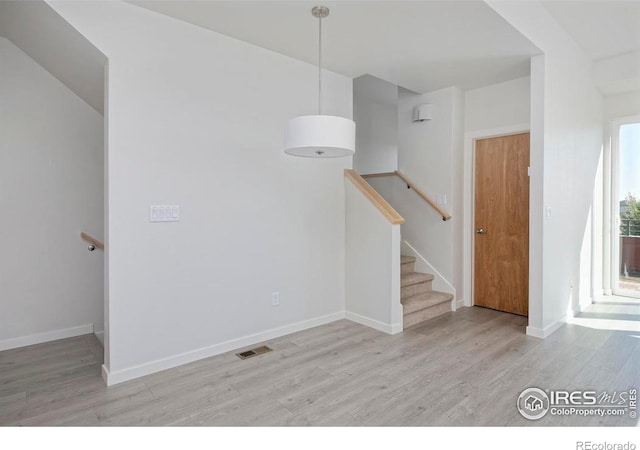 stairway with hardwood / wood-style floors