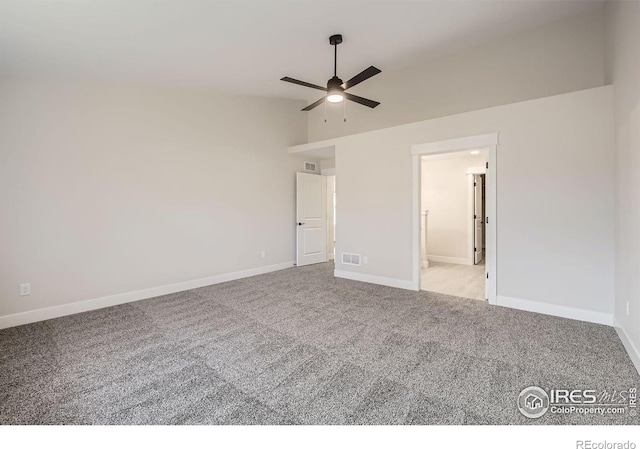 unfurnished bedroom featuring lofted ceiling, light carpet, visible vents, and baseboards