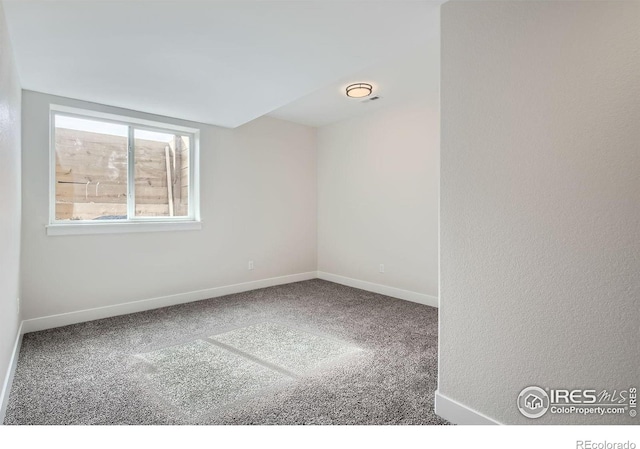 carpeted spare room with baseboards