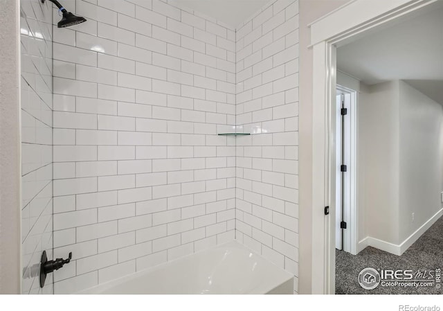 bathroom with shower / bath combination and baseboards