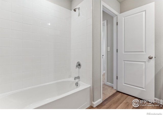 bathroom with tiled shower / bath and hardwood / wood-style flooring