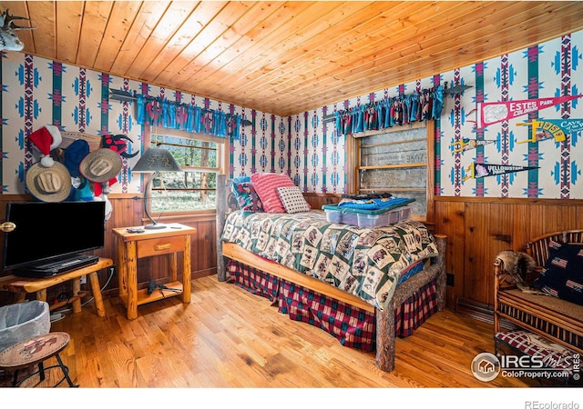 bedroom featuring hardwood / wood-style floors and wooden ceiling