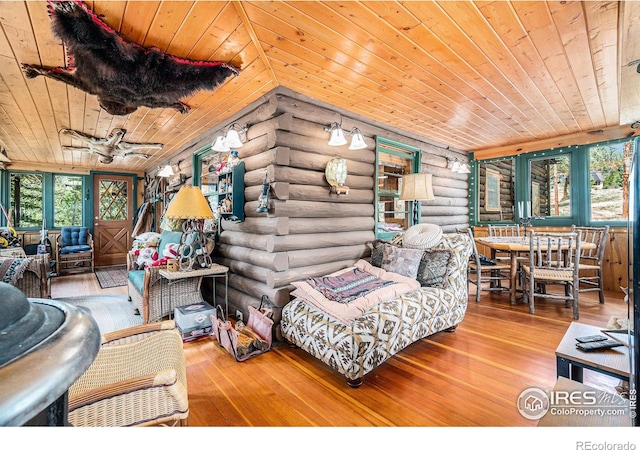 living room with ceiling fan, log walls, hardwood / wood-style flooring, and wood ceiling