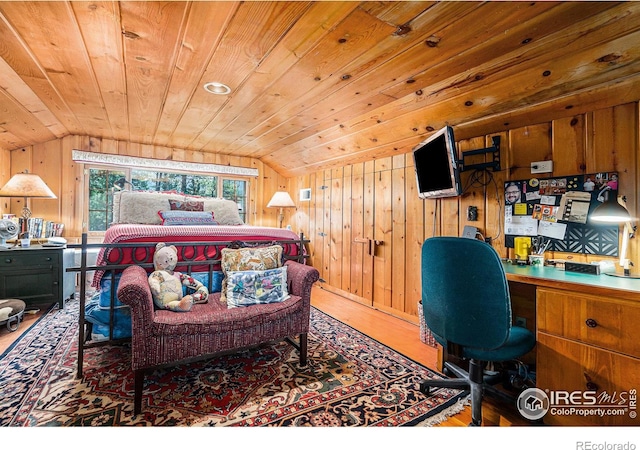 bedroom featuring wooden walls, vaulted ceiling, hardwood / wood-style floors, and wooden ceiling