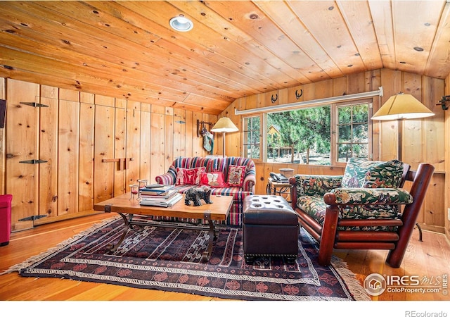 living room featuring wooden ceiling, lofted ceiling, wood walls, and hardwood / wood-style floors