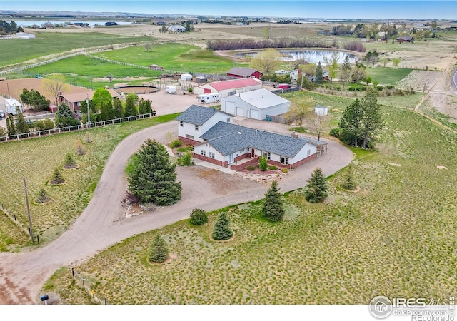 aerial view with a rural view and a water view