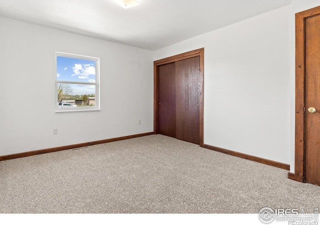 unfurnished bedroom featuring a closet and carpet