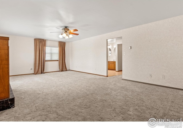 unfurnished room featuring light carpet and ceiling fan