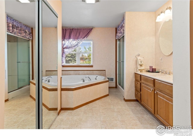 bathroom with tile patterned flooring, vanity, and separate shower and tub