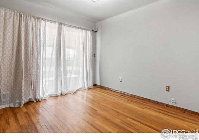 unfurnished room featuring hardwood / wood-style floors