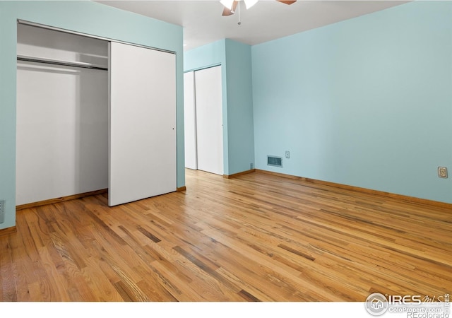 unfurnished bedroom with ceiling fan and light wood-type flooring